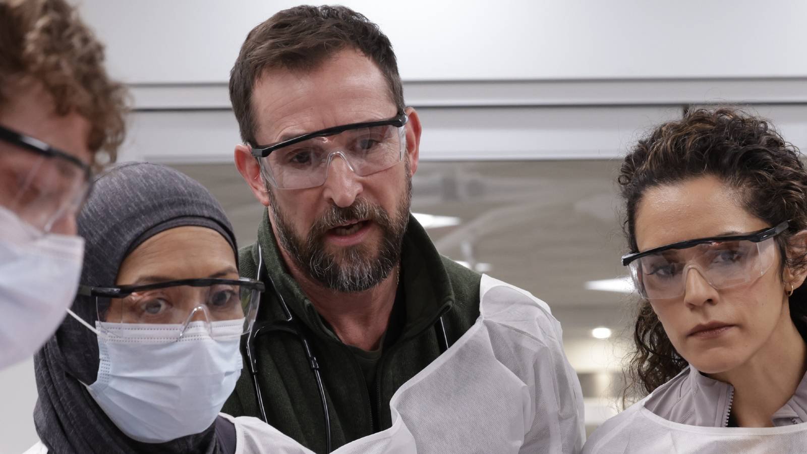 Dr. Robby and his team in The Pitt season 2 seeming started as they look over a patient.