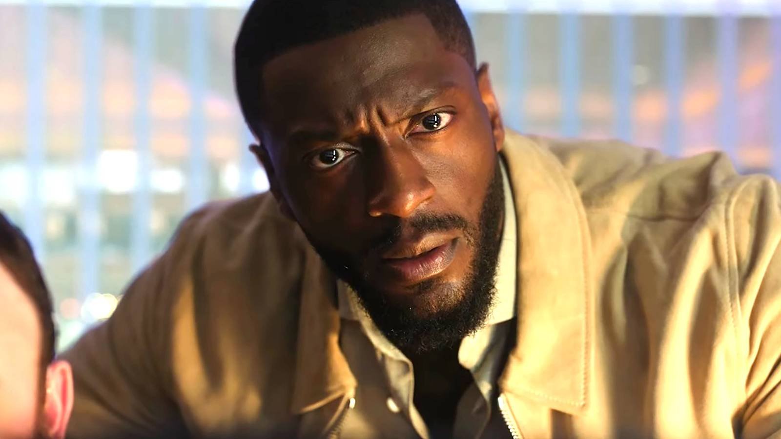Aldis Hodge as Alex looking intensely at a computer screen in Cross season 2
