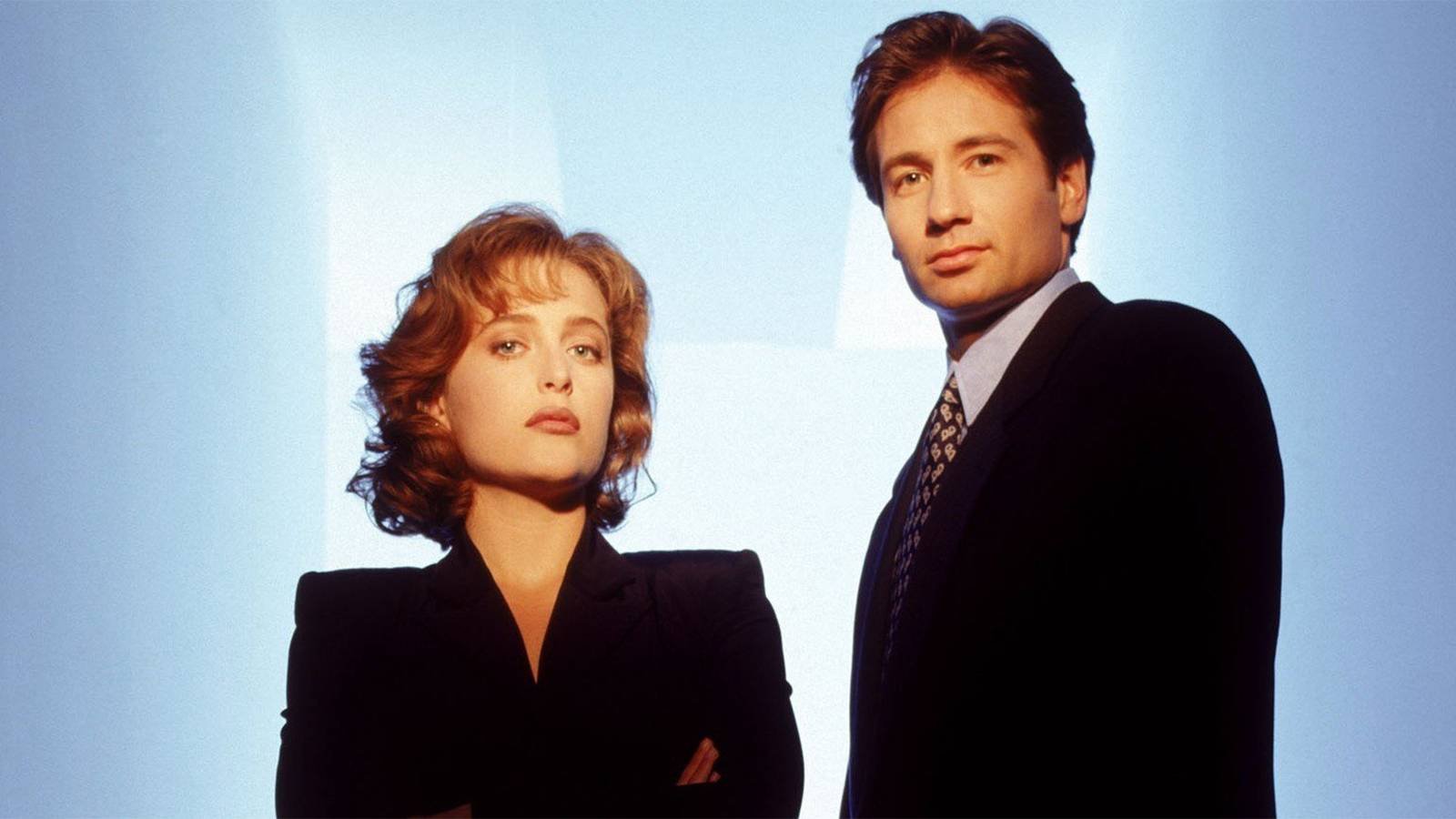 Gillian Anderson and David Duchovny standing together in a promo photo for the early seasons of T...