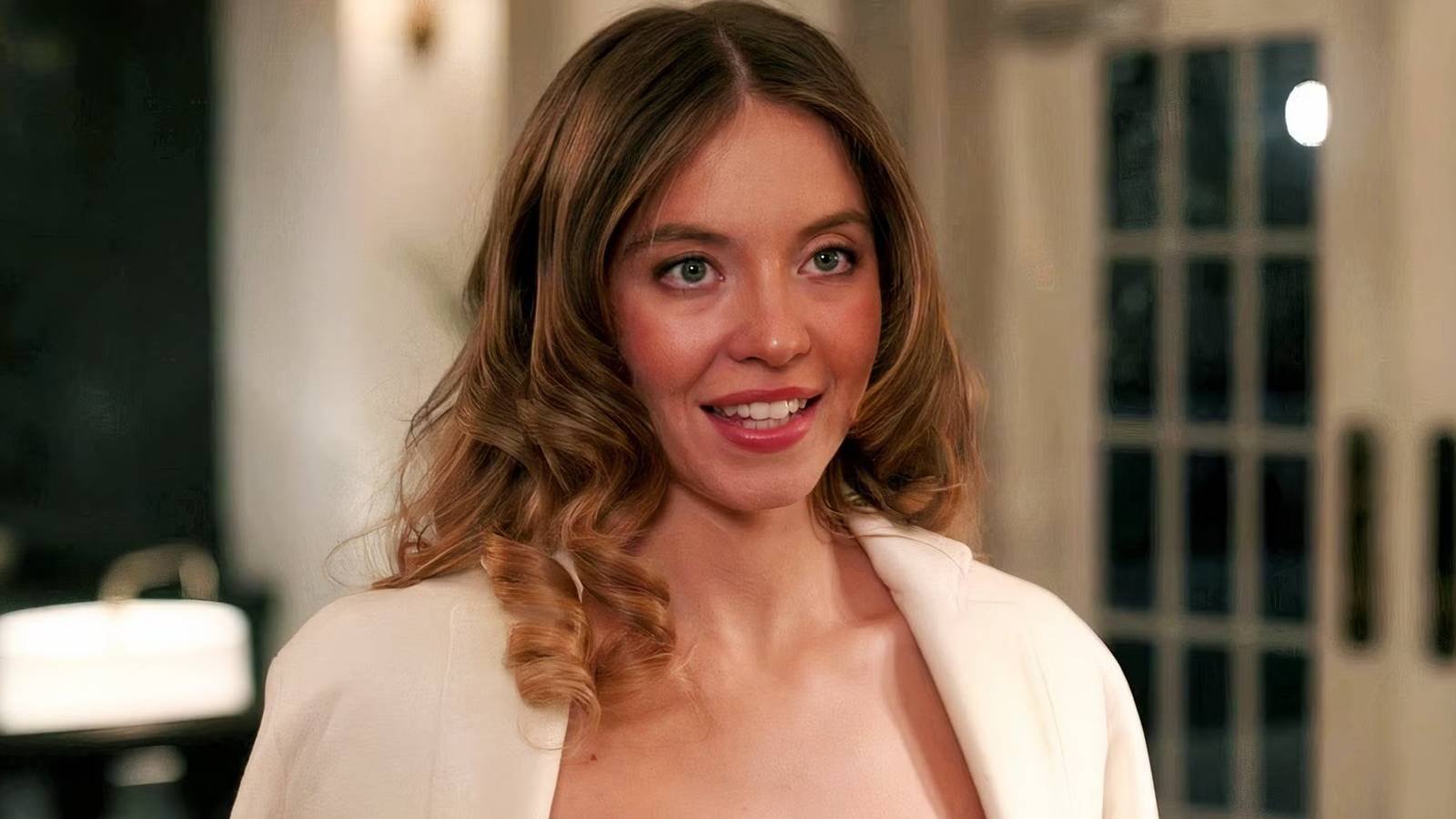 Sydney Sweeney's Millie at the hotel reception desk in The Housemaid