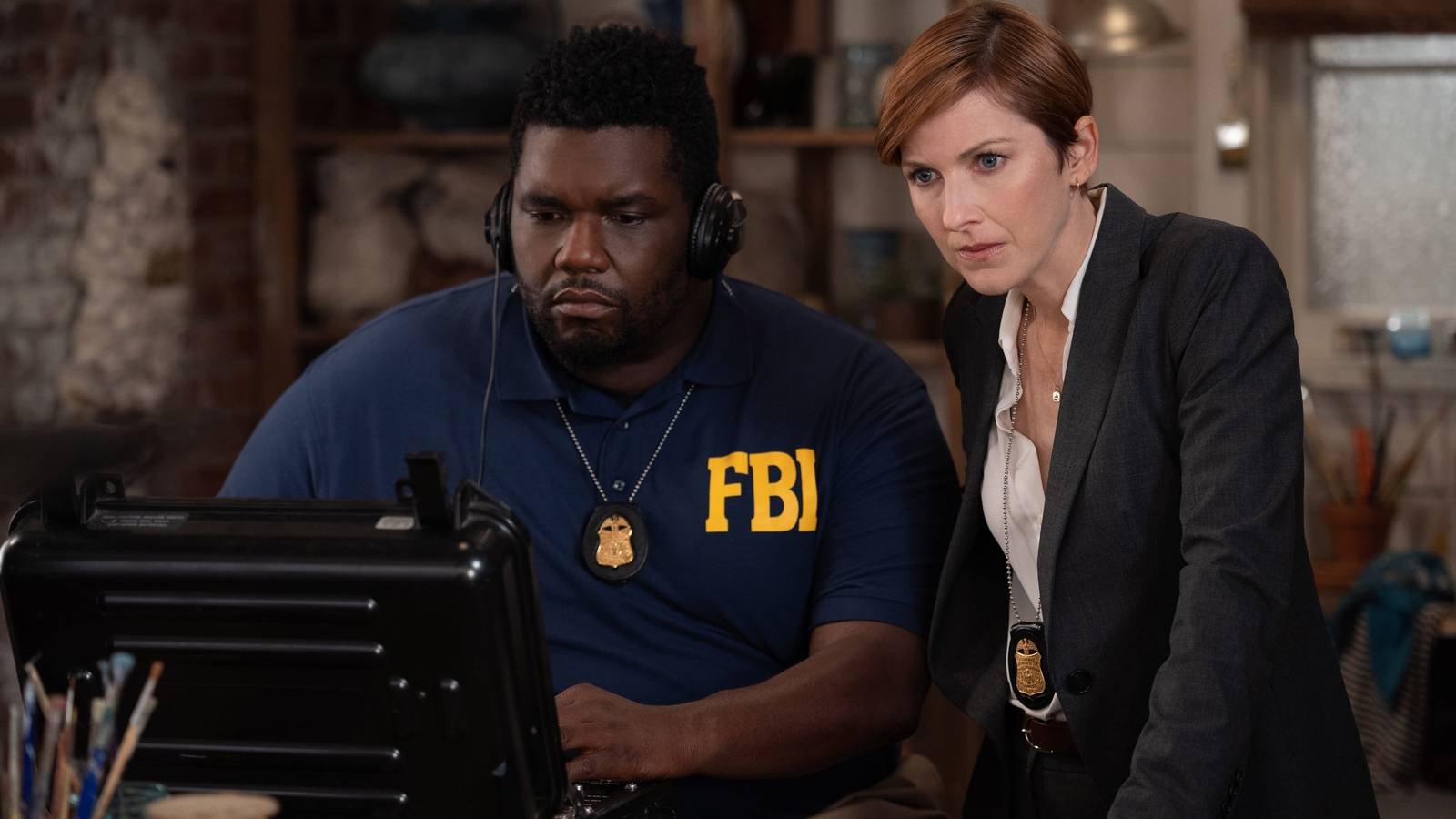 Phillip Brandon, Cora Vander Broek as FBI agents listening in during Grace and Frankie season 7