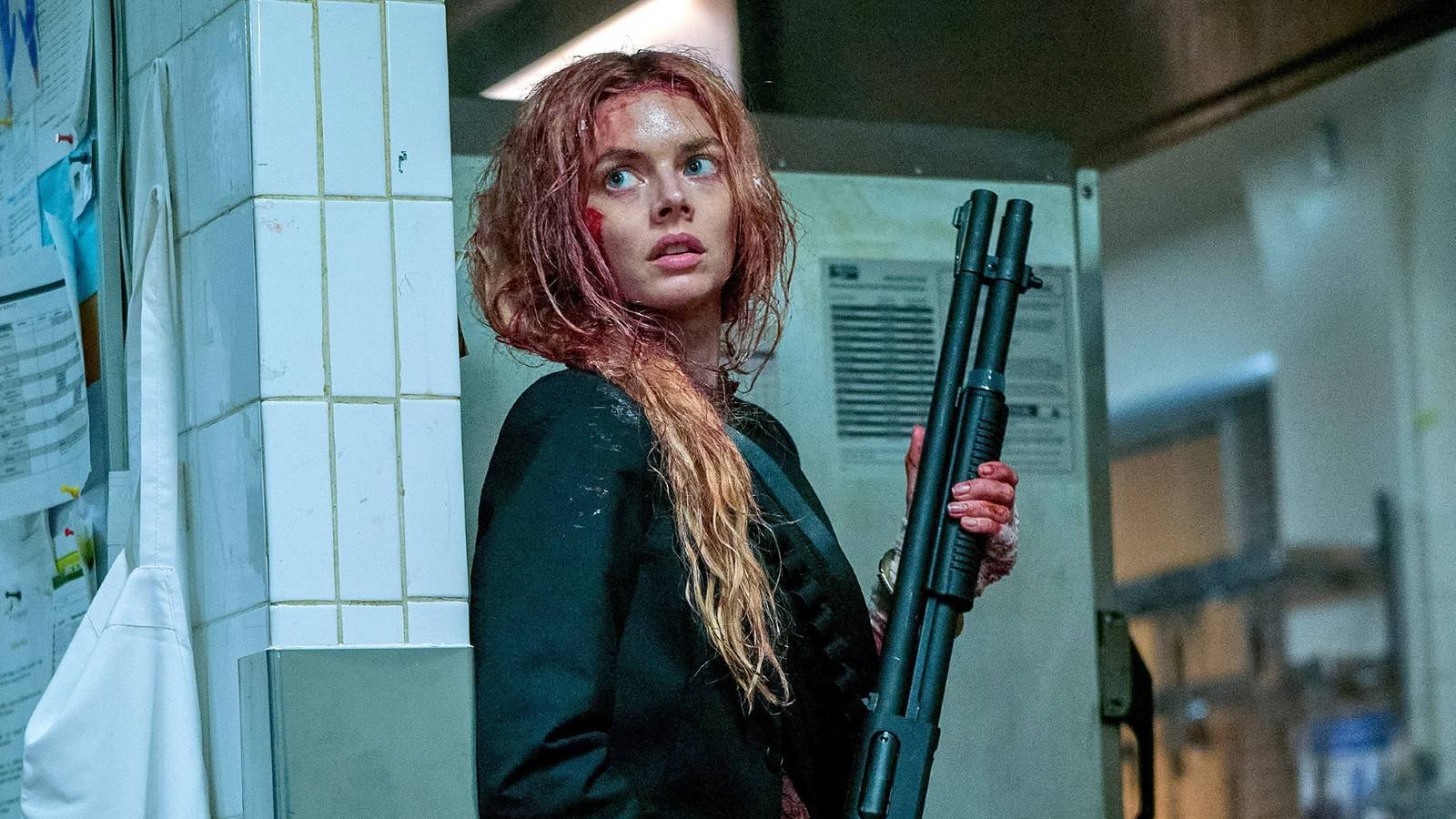 Samara Weaving holding a shotgun as a bloodied Grace in Ready or Not 2 Here I Come