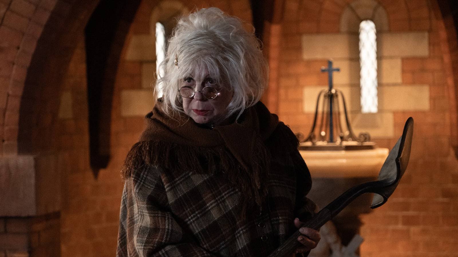 Vicki Lawrence as Lotte holding a shovel in Palm Royale season 2