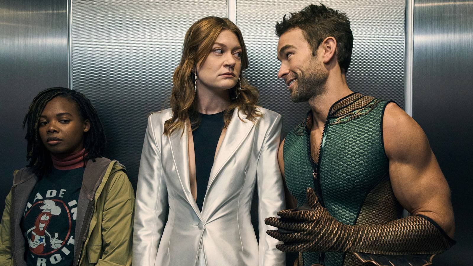 The Deep and Ashley looking at each other inside an elevator while Sister Sage stands beside them...